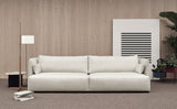 Sofá Serene con base a suelo y brazos altos en un salón Fotografía de ambiente de Joquer.